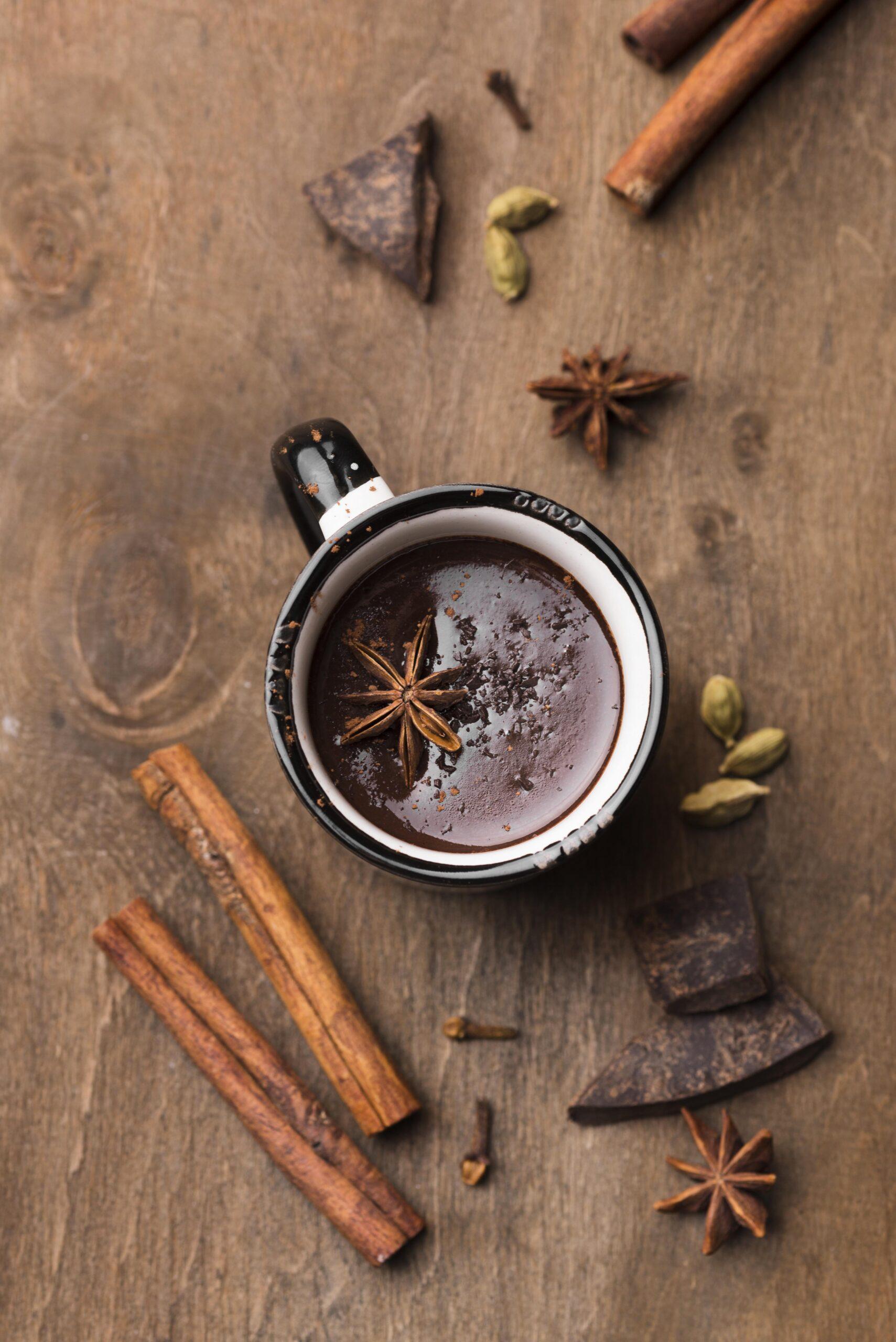 top-view-cup-with-hot-chocolate-cinnamon-table
